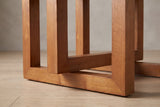 Close-up of the base: square rubberwood frames with 45-degree mitred corners, one hanging frame overlapping a standing frame