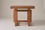 Soave side table in walnut, straight front view: thick square top, two posts, an upper and a lower rail