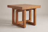 Soave square side table in walnut, three-quarter view on a warm grey studio backdrop