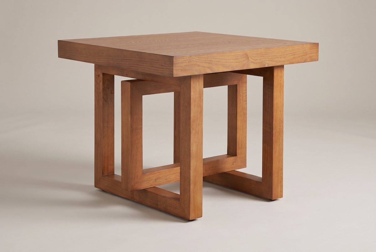 Soave square side table in walnut, three-quarter view on a warm grey studio backdrop
