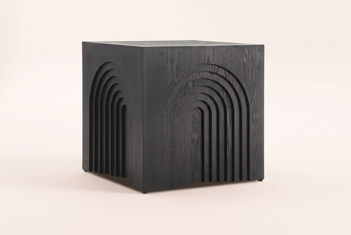Sondrio cube side table in Black, three-quarter view on a warm grey studio backdrop