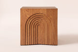 Sondrio side table, straight front view: a stepped arch of seven nested arches carved into the side