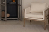 Soren accent chair with beige cushions and an exposed ash frame in a living room corner
