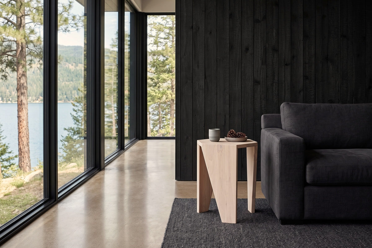 Sovana side table in Sandblast White Elm at the arm of a charcoal linen sofa in a Christina Lake house