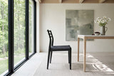 A Sperlinga dining chair in black in side profile in a Belfountain house in the Credit River valley