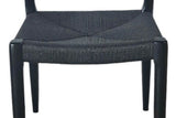 Close-up of the black paper cord seat of the Sperlinga chair, woven four ways and wrapped over the front rail