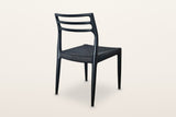 The back of the Sperlinga dining chair in black on a warm white studio backdrop: three rails