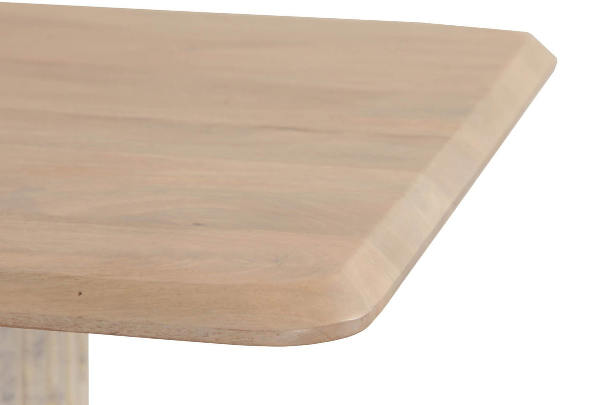 Close-up of the Staffolo top in Natural: a clipped corner with a soft bevel and the pale mango grain