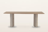 Staffolo dining table in Natural, straight front view on a warm white studio backdrop: a long mango top on two reeded marble