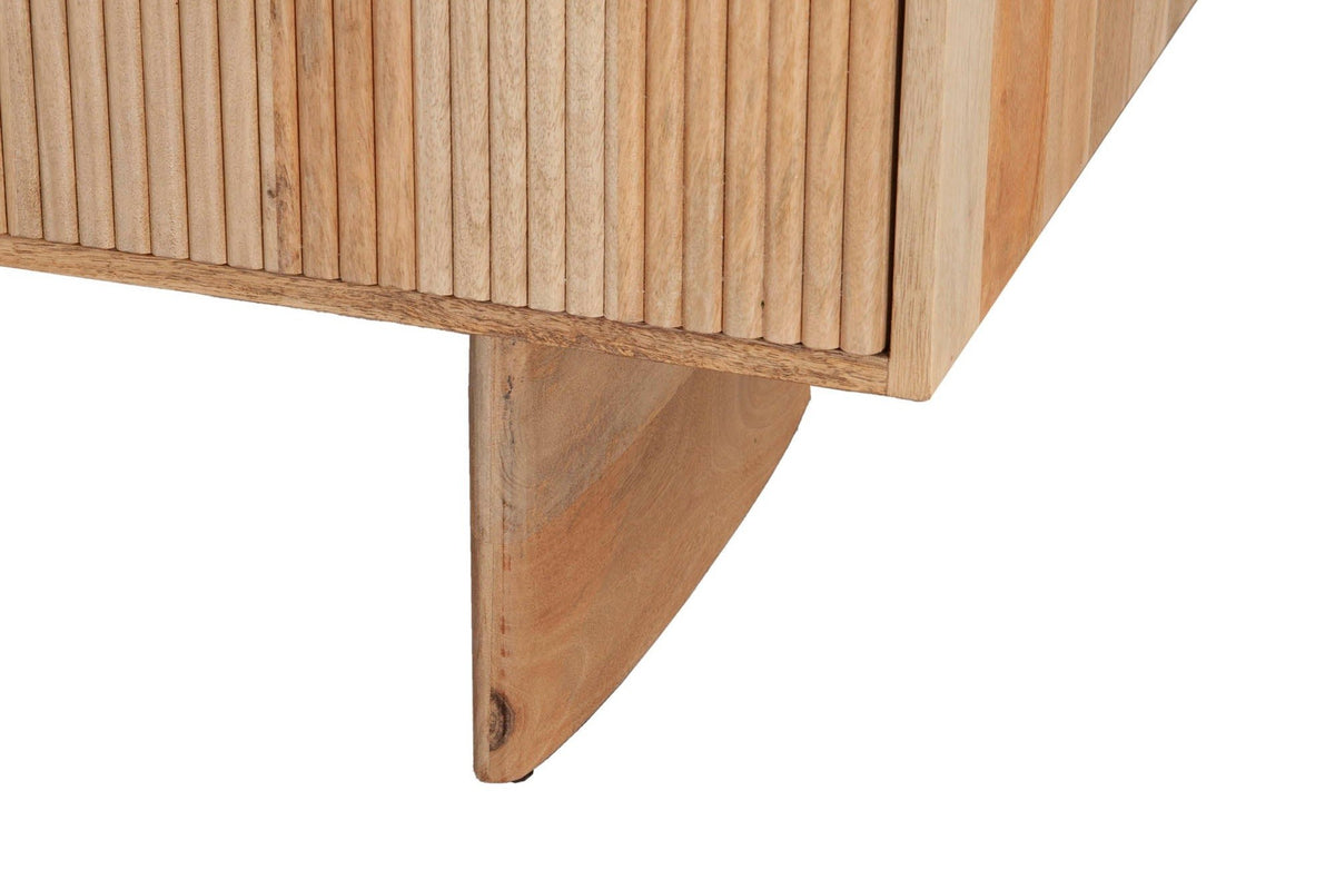Close-up of a Staffolo slab leg in Natural mango wood under the reeded doors, with its softly curved lower edge