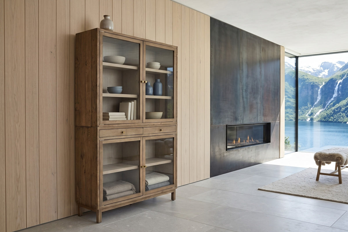 Suvereto display cabinet in Smokey Grey against pale oak boards in a Geiranger fjord house