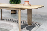 Close-up of the Sylvan table's rounded end and block leg in a dining room