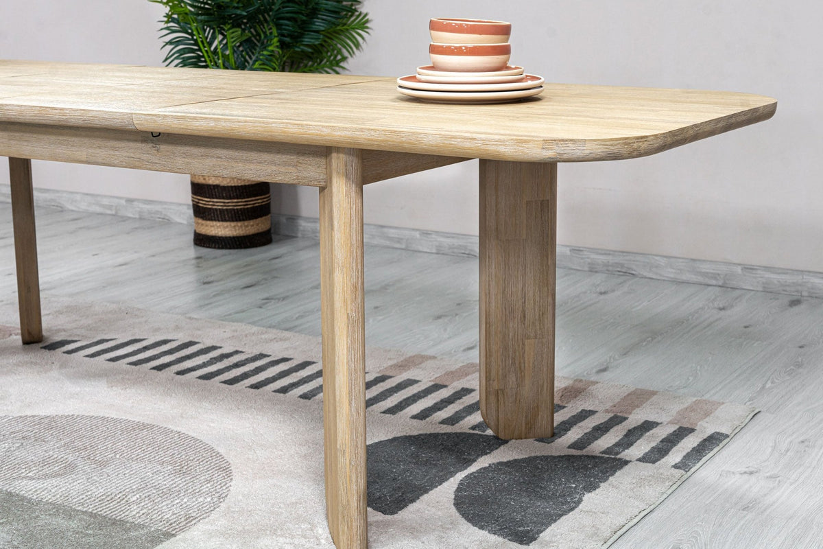 Close-up of the Sylvan table's rounded end and block leg in a dining room