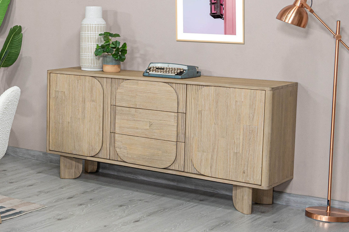 Sylvan sideboard with a vase, typewriter and copper floor lamp against a mauve wall