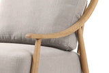 Close-up of the Tagliacozzo arm: a slim ash armrest with a rounded end on its post, curving up toward the back