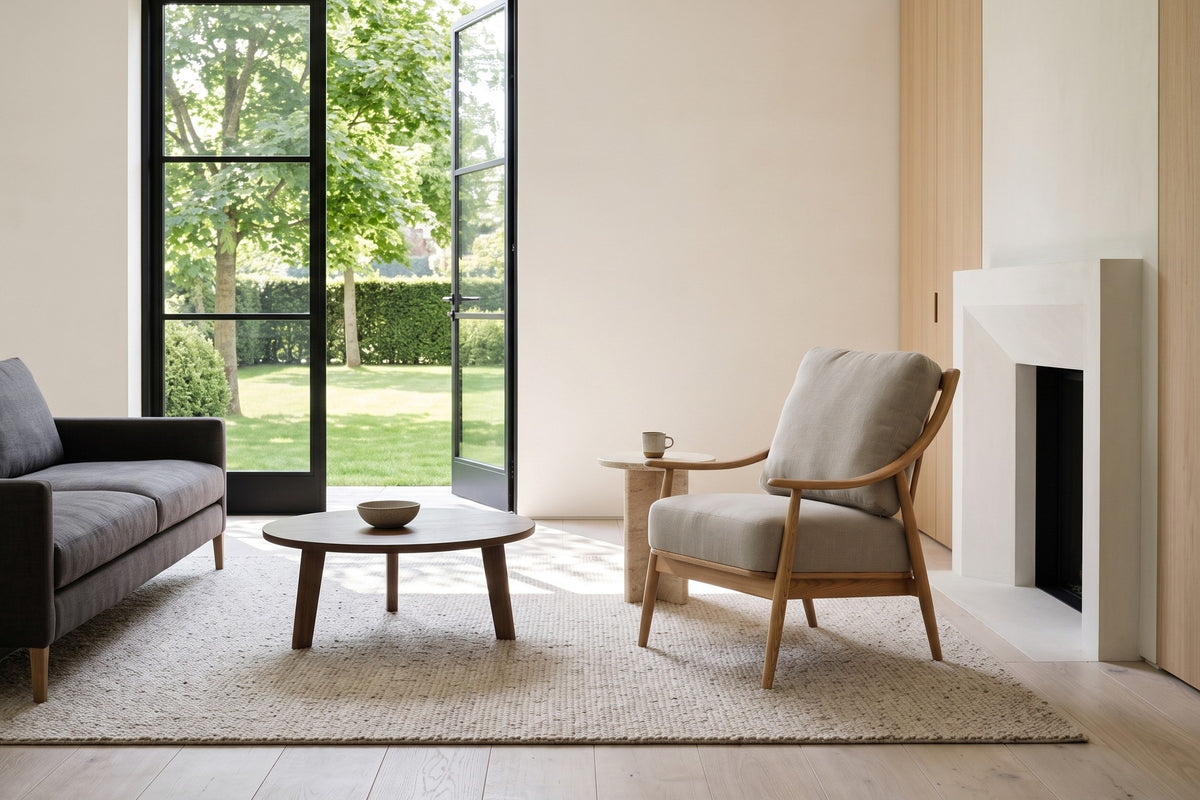 Tagliacozzo accent chair in a country house in Erin, Ontario, by a white plaster fireplace and pale oak panelling