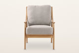 Tagliacozzo accent chair, straight front view on a warm white studio backdrop: arm posts