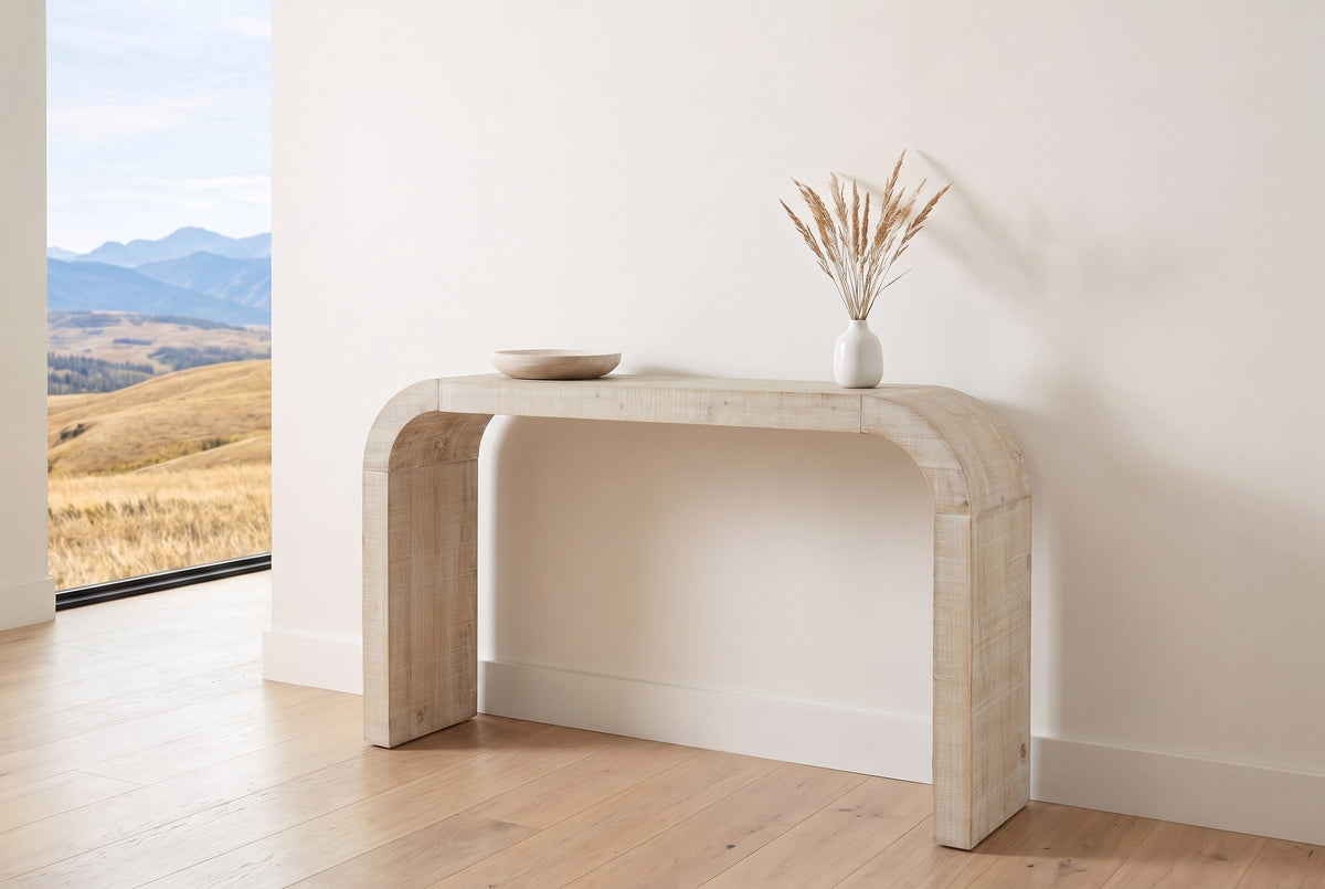 Tarvisio console table in natural in the bright entry of a Calgary foothills house, a wooden bowl and dried grasses on top