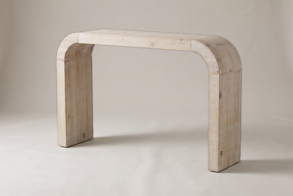 Tarvisio waterfall console table in the natural finish, three-quarter view on a warm grey studio backdrop
