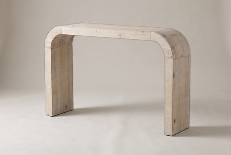 Tarvisio waterfall console table in the natural finish, three-quarter view on a warm grey studio backdrop