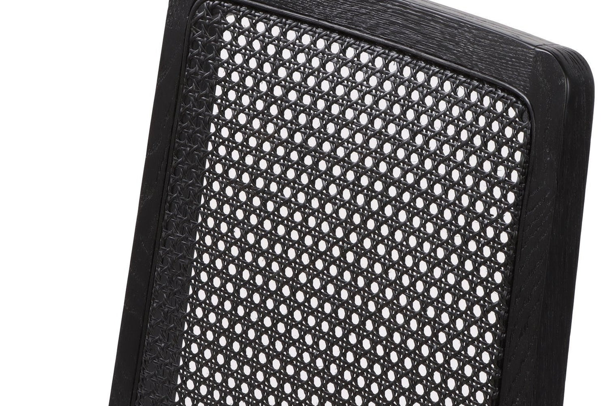 Close-up of the Teggiano back in Black: black woven cane with small round openings, set in a black ash frame