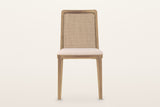 Teggiano dining chair in Natural, straight front view on a warm white studio backdrop