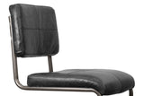 Close-up of the Tenno back and seat in black leather: the back stitched in four panels, the seat with a rolled front edge