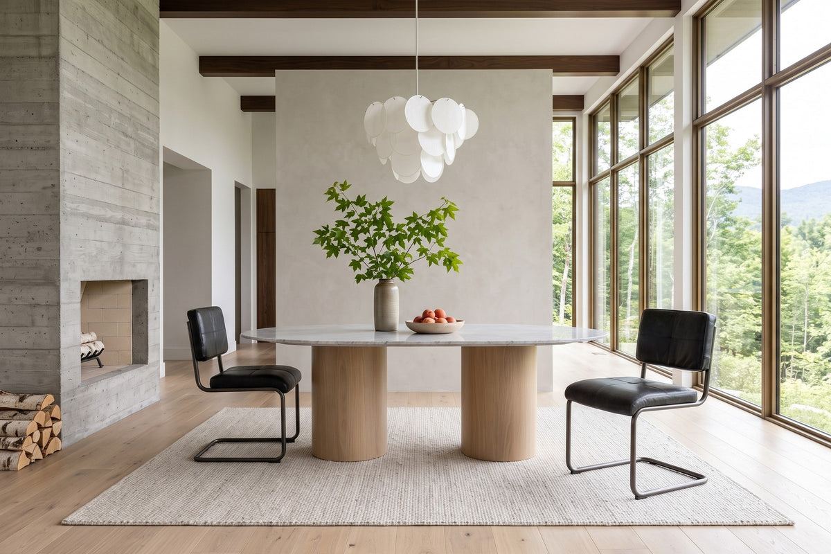 Tenno dining chairs in Black at the two ends of an oval marble table in a Sutton house