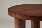 Close-up of the rim of the Teramo top: walnut-toned burl figure with clusters of dark eyes on the face and down the edge