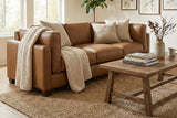 Thatcher Antique Sienna leather sofa in a bright living room with a wood coffee table