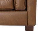 Close-up of Thatcher leather track arm and dark wood block leg