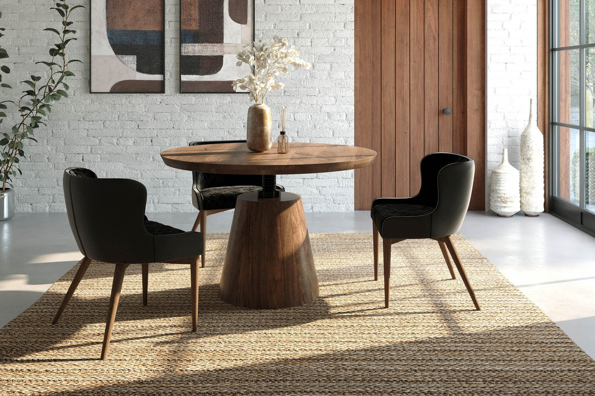 Thorne round acacia dining table with black chairs in a white brick room with tall windows