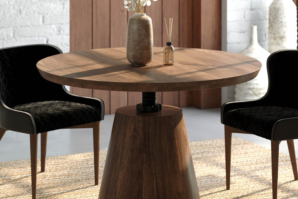 Thorne round table close up, showing the acacia top, iron collar and tapered pedestal