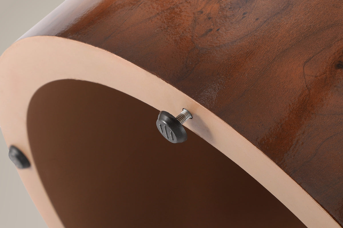 Underside of a drum: hollow inside, a tan-painted base ring and a black screw-in glide