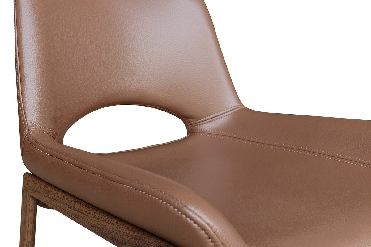 Tobin dining chair close-up of the cut-out back, stitched seat and walnut-finished frame