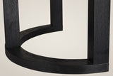 Close-up of one Tolmezzo table base: square black posts standing on a curved half-moon foot, with the open wood grain showing