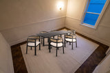 The Tolmezzo dining set on an ivory rug over a dark herringbone floor in a Toronto townhouse dining room at dusk