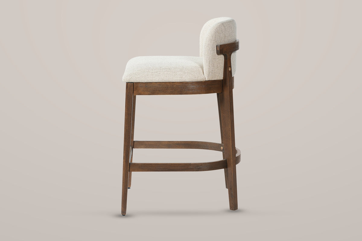 Torgiano counter stool in side view: 26.65 inch seat height, the slim rail behind the back and the bent-wood footrest