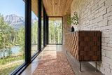 Trequanda sideboard in Brown seen from the end against dry-stack limestone in an Exshaw house in the Bow Valley