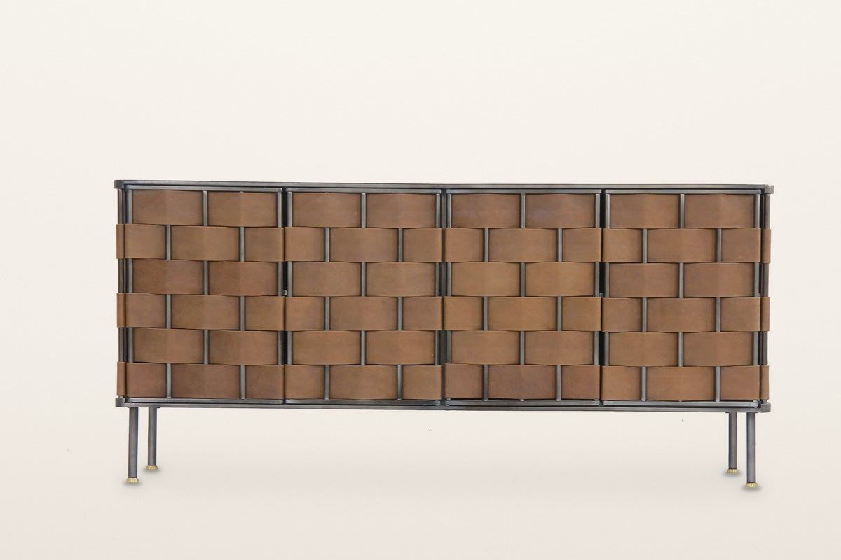 Trequanda sideboard in Brown, straight front view on a warm white studio backdrop: six rows of wide leather straps over and u