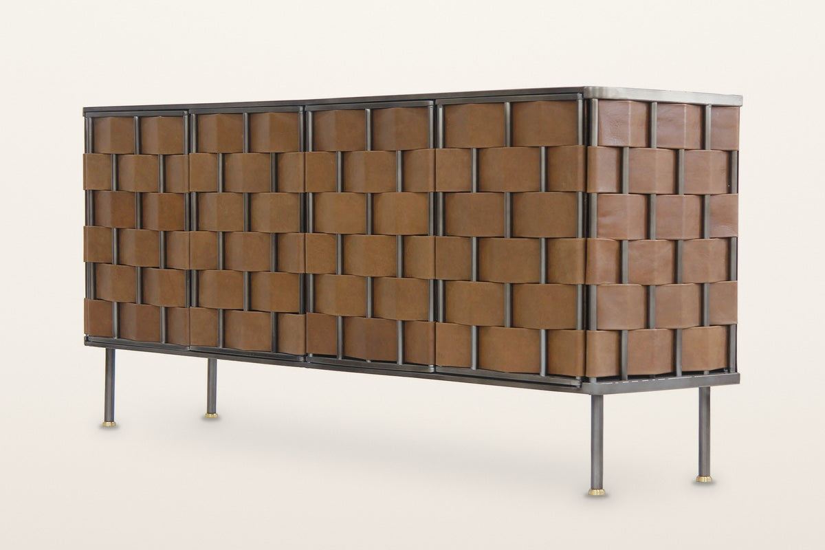Trequanda woven leather sideboard in Brown, three-quarter view on a warm white studio backdrop: four doors and the ends woven