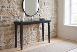 Treviso console table in Black against an old limestone wall in a Quebec City front hall
