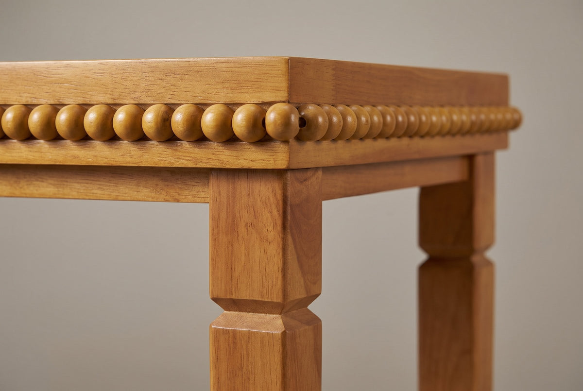 Close-up of a Treviso corner: the last bead standing past the edge, the band and apron