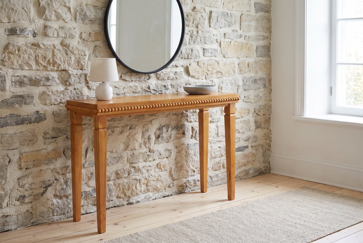 Treviso console table in Natural against an old limestone wall in a Quebec City front hall