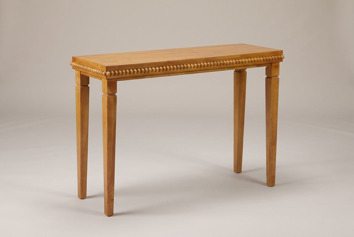 Treviso console table in Natural, three-quarter view on a warm grey studio backdrop
