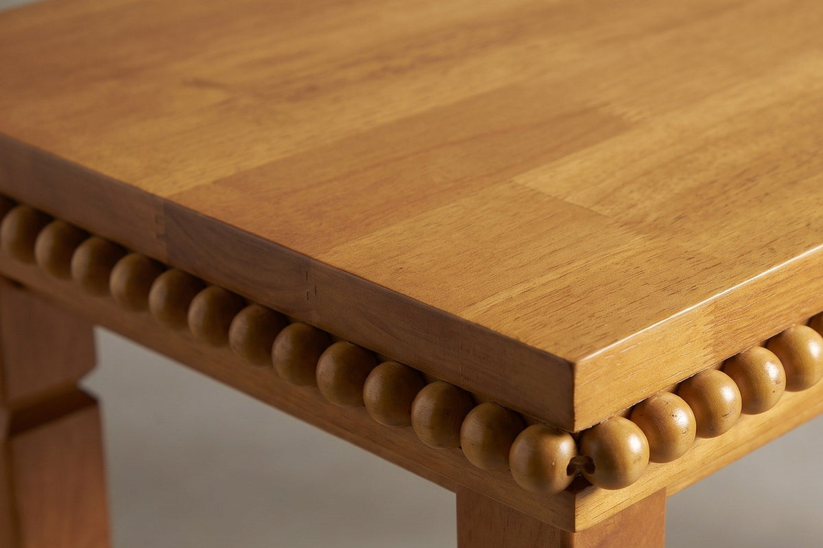 Close-up of the Treviso top: narrow rubberwood boards glued edge to edge, the square edge and the bead row beneath it