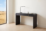 Trieste console table used as a slim desk in a Calgary study nook, a black desk lamp, a mug and a notebook