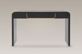 Trieste console table in matte black, straight front view: one centred drawer edged in a gold-tone U, two slab legs