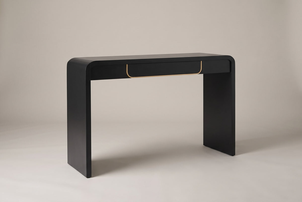 Trieste waterfall console table in matte black, three-quarter view on a warm grey studio backdrop