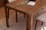 Tristan mango wood tabletop corner with natural grain and a rounded leg